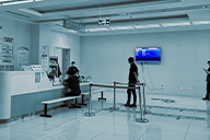 A digital display mounted on the wall provides health tips to patients